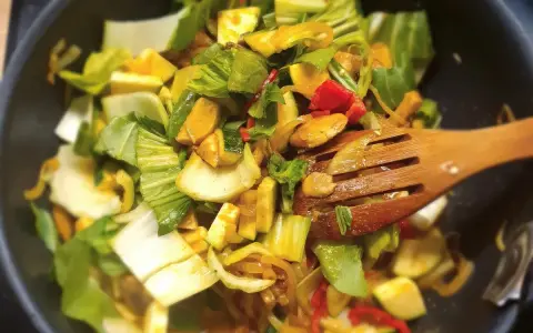 Kolorowe warzywa, w tym kapusta pak choi, smażone na patelni. Idealne do szybkich i zdrowych dań, inspiracja do kapusta pak choi przepisy.
