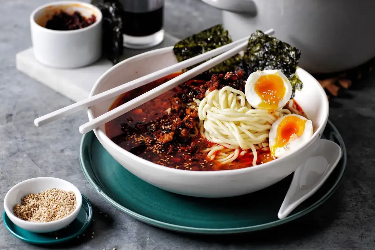 A miseczce pyszny ramen: makaron, jajko na pół, mięso mielone, nori i sezam. Idealny na rozgrzewkę, zastanawiasz się ramen co to? To danie, które warto spróbować!